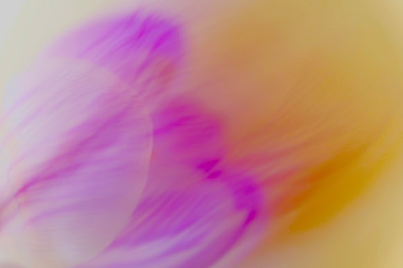 Abstract image with blurred pink and orange swirls.
